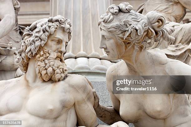 man and woman conversing the atena statue in vienna, austria - classical greek bildbanksfoton och bilder