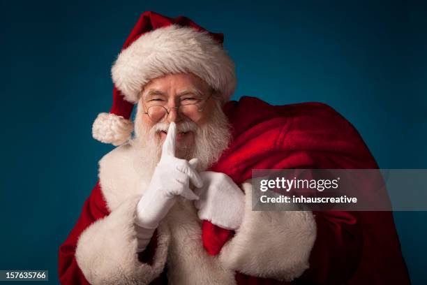 pictures of real santa claus withfingers on lips - finger on lips stock pictures, royalty-free photos & images