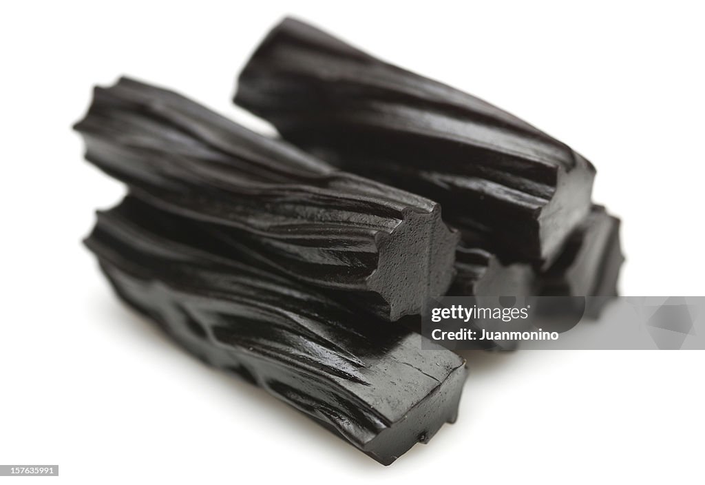 Close-up view of five pieces of licorice on white background