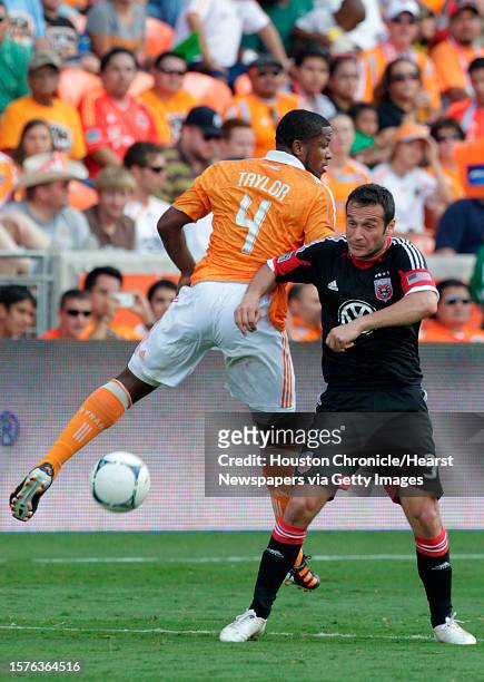 Houston Dynamo's Jermaine Taylor attempts to get possession of ball from D.C. United's Hamdi Salihi in the second half at BBVA Compass Stadium on...