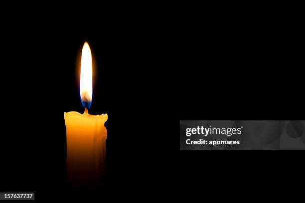 single lit candle with quite flame - pit stockfoto's en -beelden