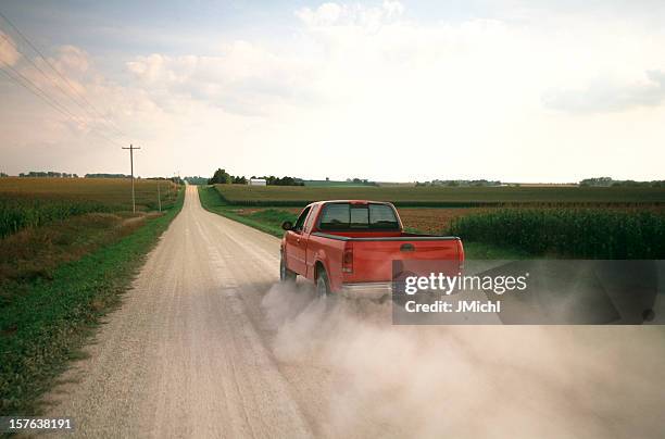 red pick-up truck sie einen dusty midwest road ab. - new zealand and farm or rural stock-fotos und bilder