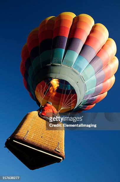 brightly colored hot air balloon launching wide  angle close-up - air balloon stock pictures, royalty-free photos & images