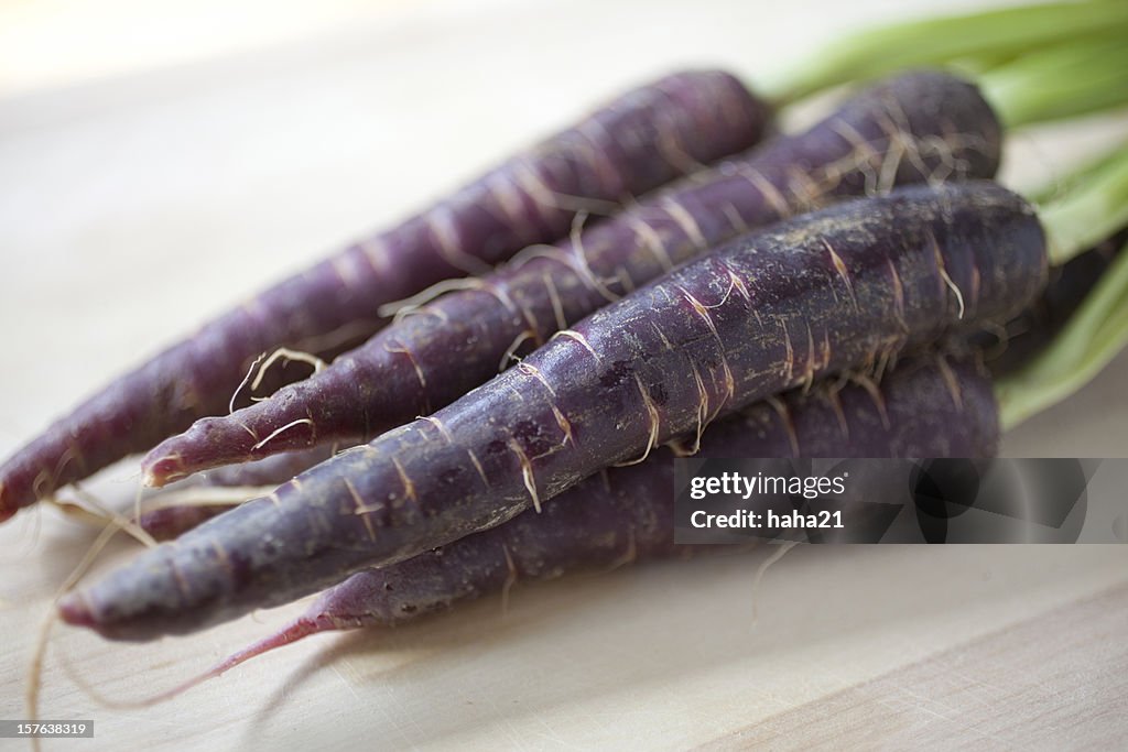 An image of four purple nutritious carrots