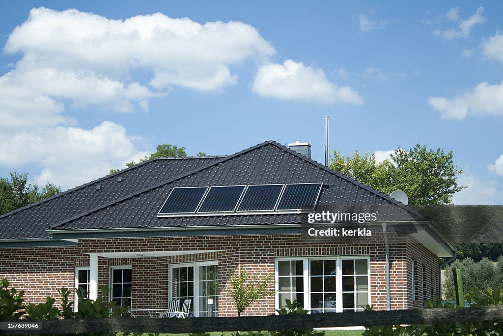 Modern bungalow with 4 small solar panels on roof