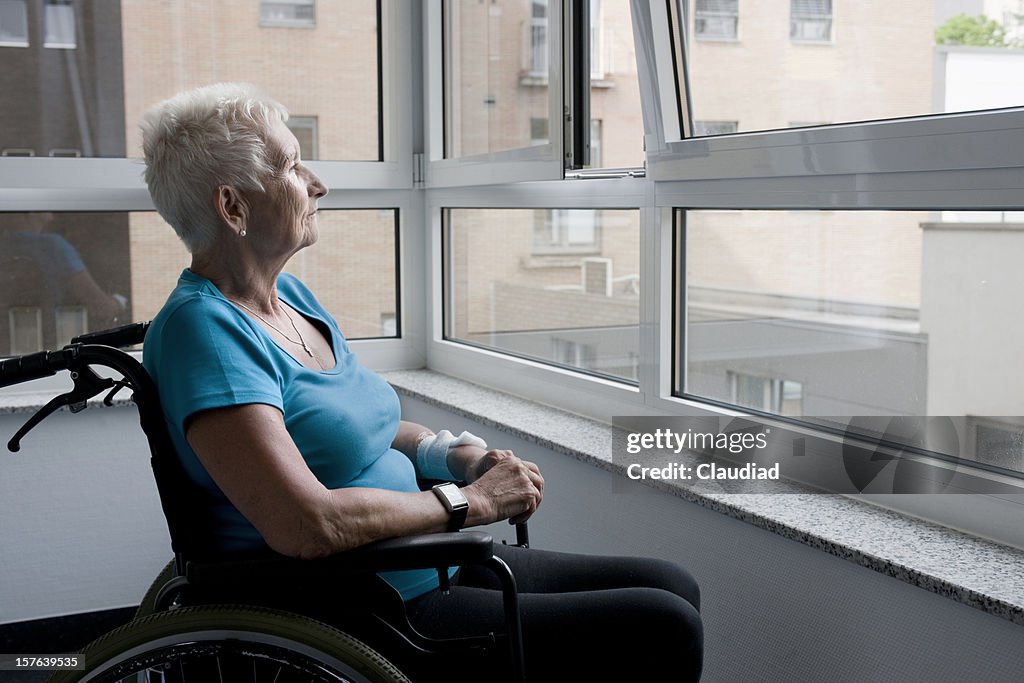 Mature woman sitting in wheelchair