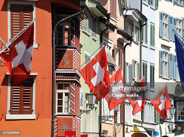 switzerland zurich city with flags on building facade - zurich switzerland stock pictures, royalty-free photos & images