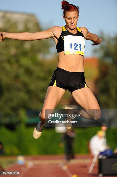 sportlerin im long jump - woman long jump stock-fotos und bilder