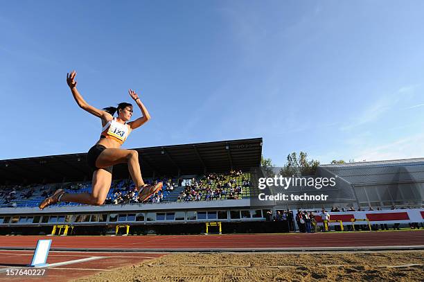 female athlete jumping - long jump stock pictures, royalty-free photos & images