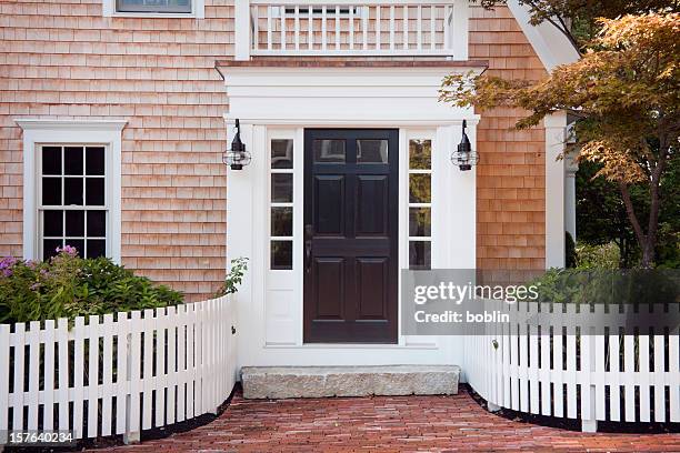 entryway of brick new england home with picket fence - voordeur stockfoto's en -beelden