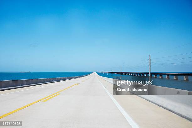 endless straight road over the ocean - florida bridge stock pictures, royalty-free photos & images