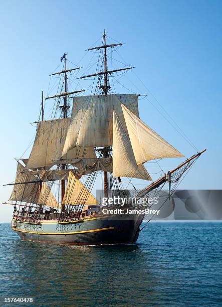 tall ship sailing open seas on sunny morning - tall ship stock pictures, royalty-free photos & images