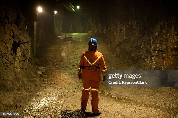 woman mine worker under ground in a tunnel. - pit shaft stock pictures, royalty-free photos & images