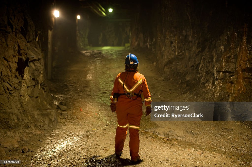 Woman Mine Worker under ground in a tunnel.