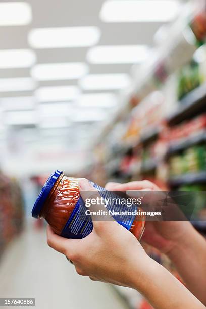 woman holding jar of food - nutrition label stock pictures, royalty-free photos & images