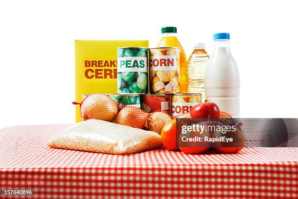 selection of basic foods on gingham cloth isolated against  white - rice food staple stockfoto's en -beelden