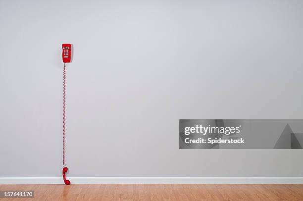 red telephone in empty room - waiting phone stock pictures, royalty-free photos & images