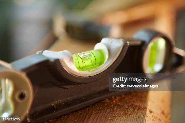 level sitting on a wooden beam - spirit level stock pictures, royalty-free photos & images