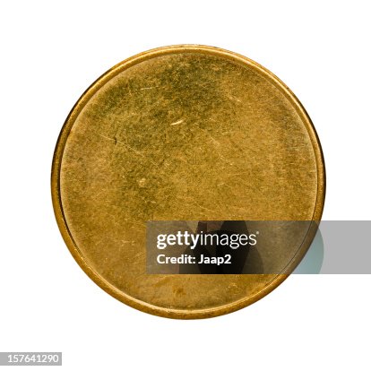 Single used blank brass coin, top view isolated on white Single used blank brass coin, top view isolated on white