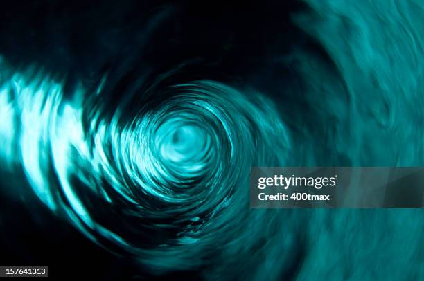 a beautiful clear teal water vortex - draaikolk stockfoto's en -beelden