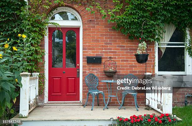 red outside door with a patio and seating - brick house stock pictures, royalty-free photos & images