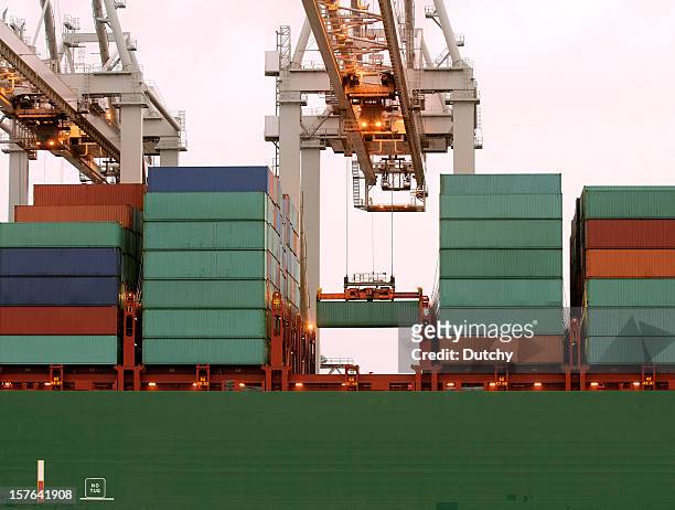 loading of a large container ship in rotterdam - shipping containers green red stock pictures, royalty-free photos & images