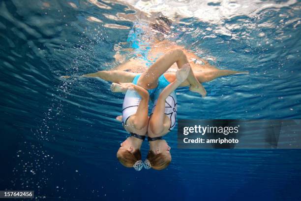 beautiful synchronized swimming unity - woman swim team stock pictures, royalty-free photos & images