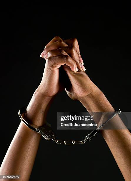 handcuffed hands - women in prison stock pictures, royalty-free photos & images
