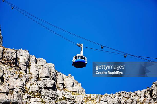looking up at modern cable car ascending table mountain - cape town cable car stock pictures, royalty-free photos & images
