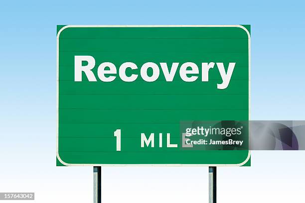 highway road sign; recovery one mile - mile stockfoto's en -beelden