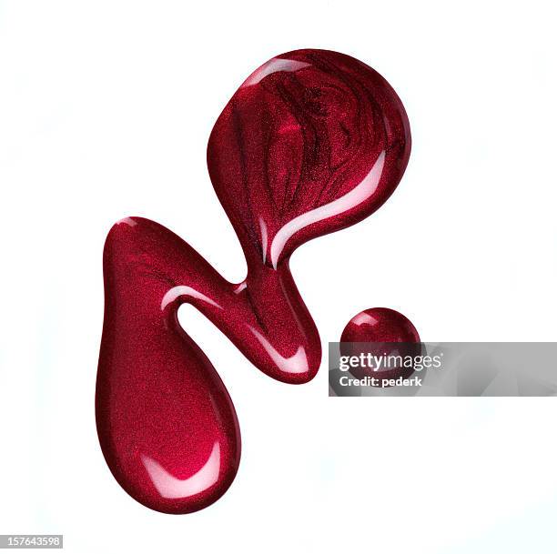 some spilled red nail polish on a white background  - red nail polish stockfoto's en -beelden