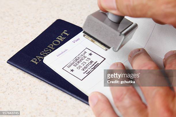 stamping passports - emigration and immigration stock pictures, royalty-free photos & images