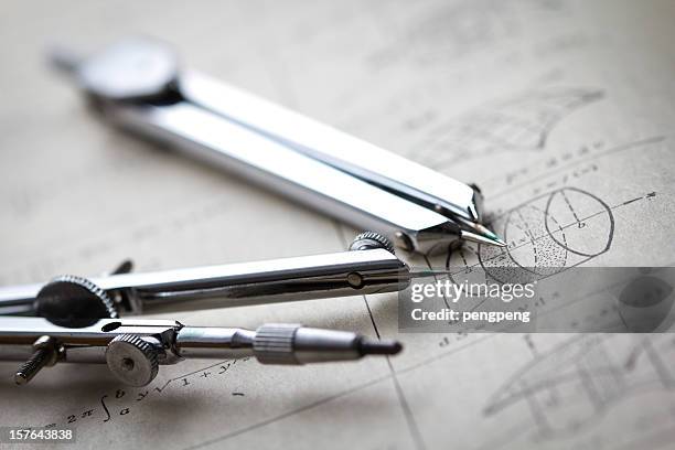 two compasses on a math worksheet - mathematics stock pictures, royalty-free photos & images