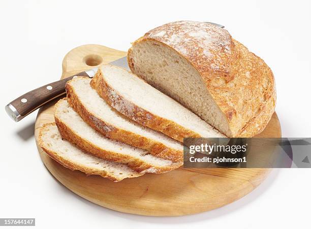 sliced fresh bread on a wooden cutting board - bread knife stock pictures, royalty-free photos & images