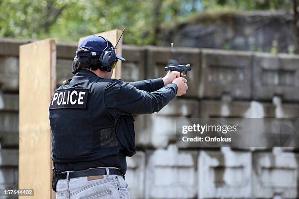 man shooting 9mm handgun shooting range - target shooting stock pictures, royalty-free photos & images