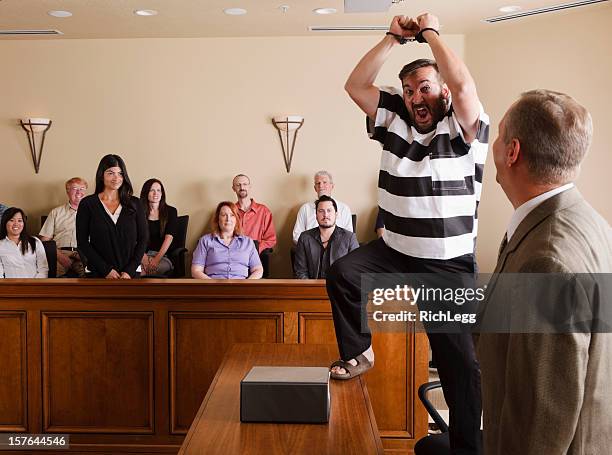 prisoner celebrating in court - handcuffed man standing in courtroom stock pictures, royalty-free photos & images