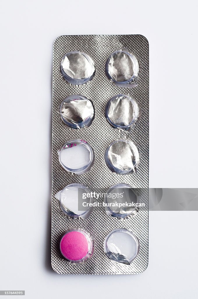 Blister pack with one pink pill remaining, close-up