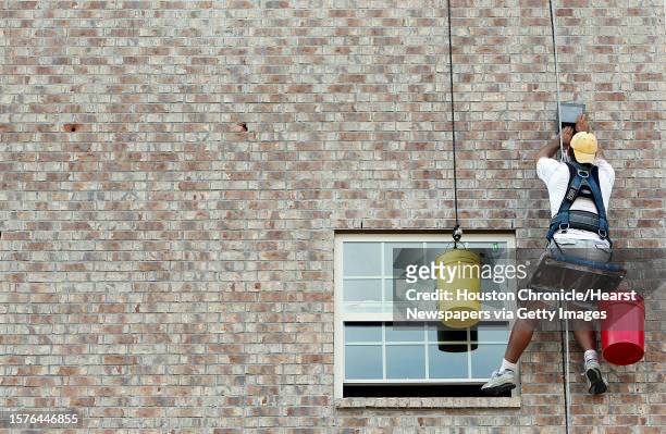 Manuel Salva, high-rise construction worker, works in the exterior of the 3rd floor of a new residential development along Live Oak Street in the...