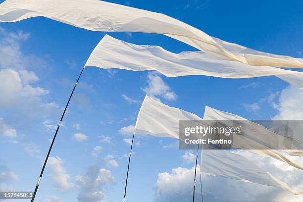 white flags against blue sky - buddhist flag stock pictures, royalty-free photos & images