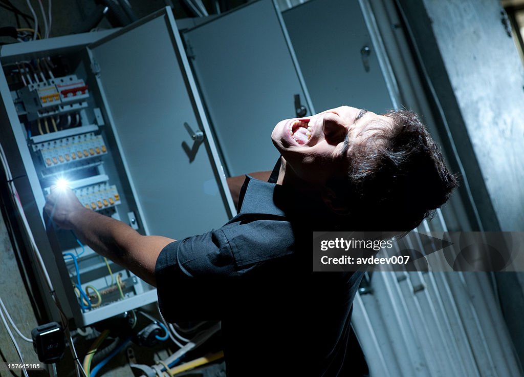 Man getting shocked by electricity on a breaker