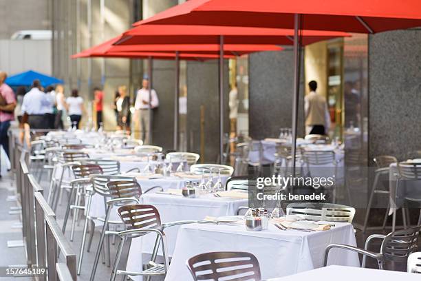 sidewalk restaurant - patio umbrella stock pictures, royalty-free photos & images