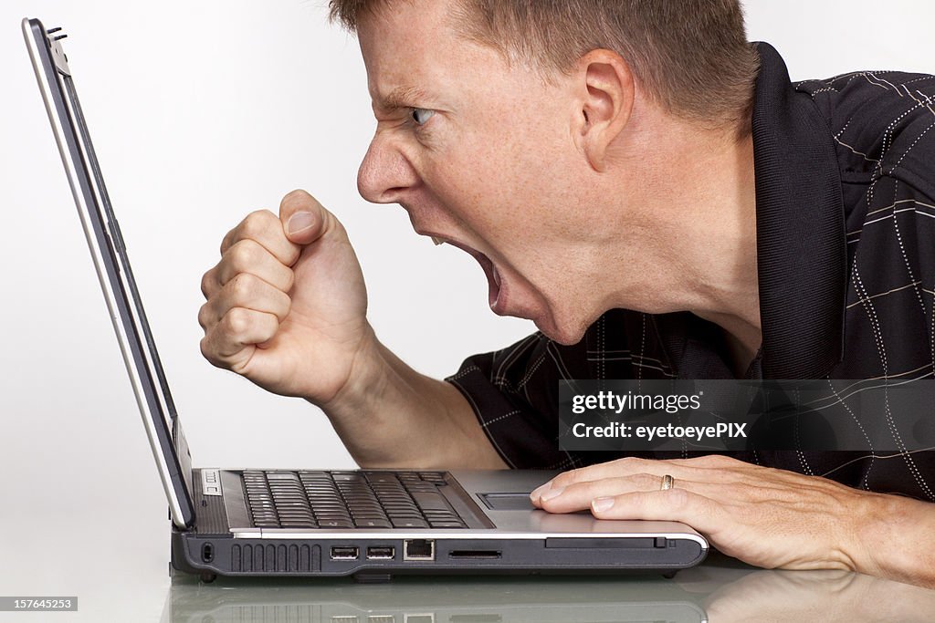 Angry man with laptop computer – fist