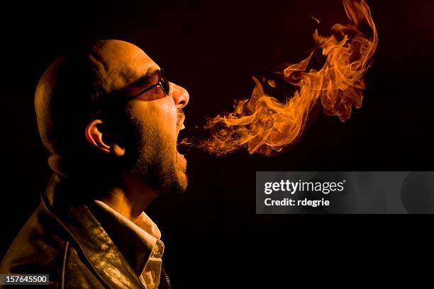 man breathing fire - heartburn, bad breath, or anger - bad breath stock pictures, royalty-free photos & images