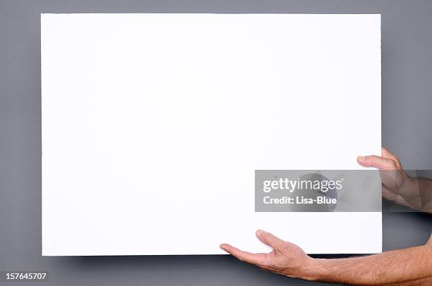 hands holding blank paper sign.copyspace - man holding placard stock pictures, royalty-free photos & images