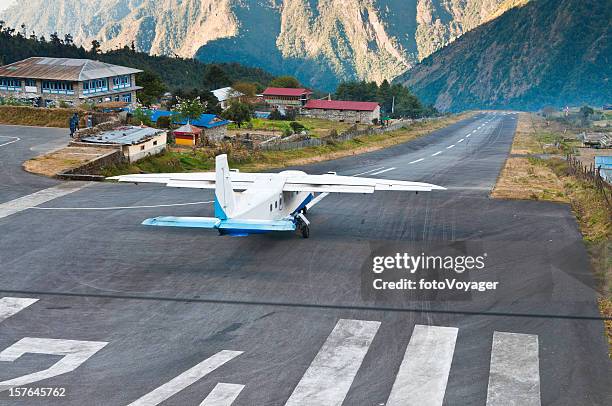 airplane taking off lukla airport dramatic mountain runway himalayas nepal - airport runway stock pictures, royalty-free photos & images