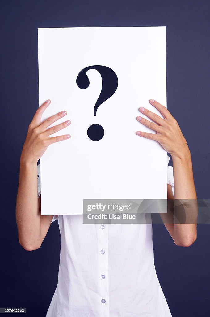 Woman Holding Question Mark Paper In Front Of Face