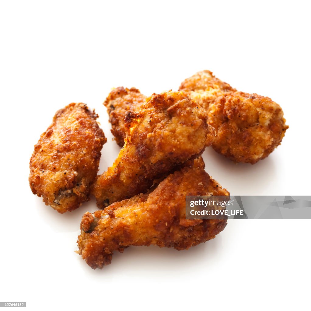 Batch of cooked chicken wings isolated on white