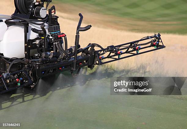 spraying liquid fertilizer on a golf course - golf turf stock pictures, royalty-free photos & images