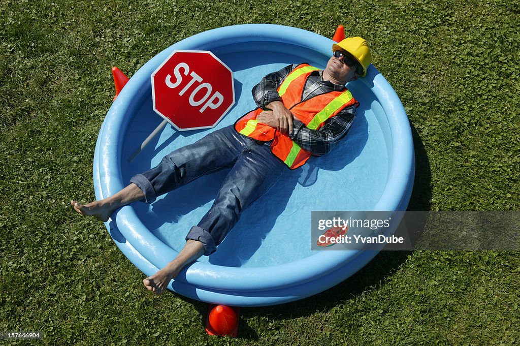 Heat wave construction worker in swimming pool