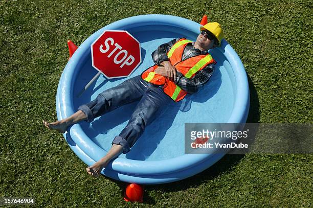 heat wave construction worker in swimming pool - time off work stock pictures, royalty-free photos & images
